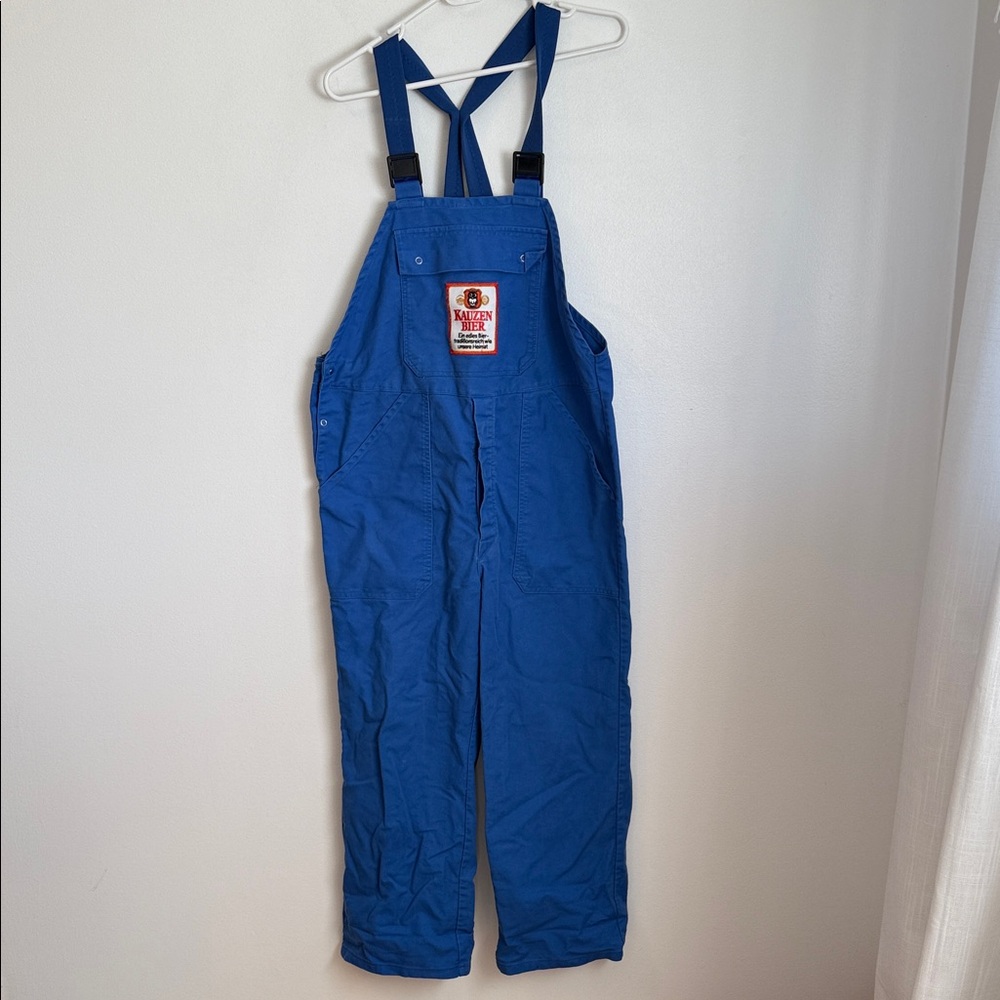 Preowned women’s blue overalls with adjustable straps.